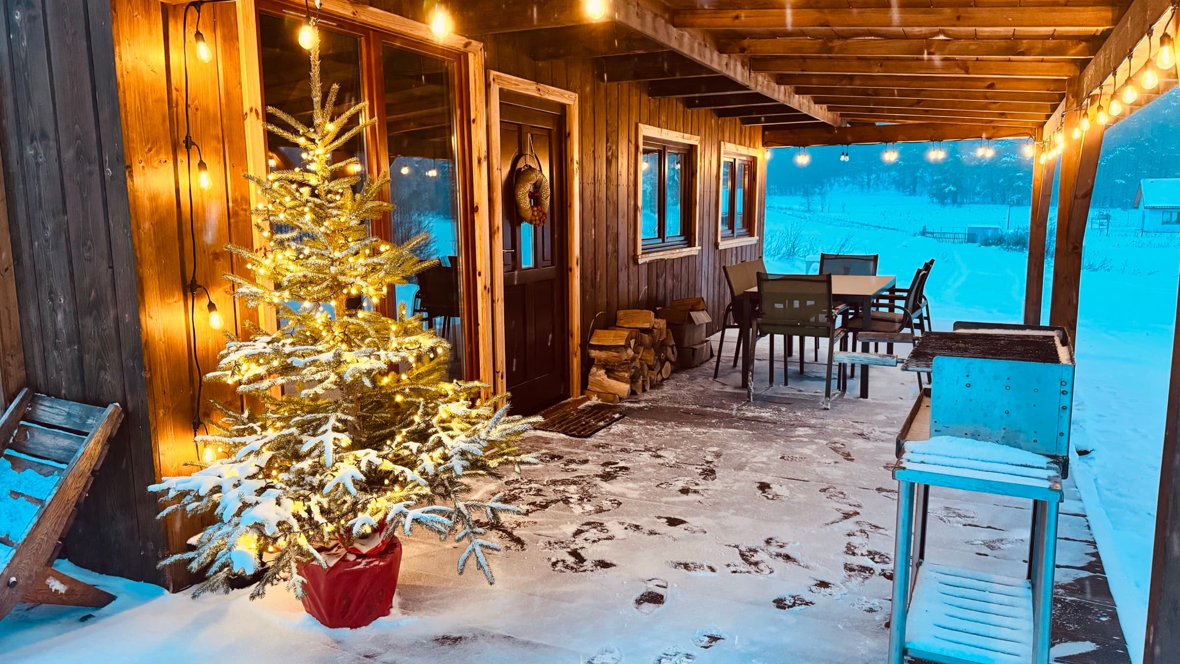 Dobra Chata at dusk — wooden cabin with a hot tub at the forest edge in Masuria